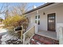 Inviting front porch with brick steps and updated wood railing at 410 N Lamar St, Roxboro, NC 27573