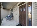 Cozy front porch with seating and a stylish front door with glass accents at 50 Setter Ct, Angier, NC 27501