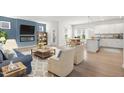Bright open-concept living room with fireplace, stylish furniture, and dining area at 60 Commons Cir, Clayton, NC 27520