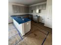 Kitchen with gray cabinets, hardwood floors, and blue countertop covers at 60 Commons Cir, Clayton, NC 27520
