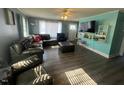 Spacious living room with updated floors, a large TV, and lots of seating at 606 N Orange Ave, Dunn, NC 28334