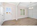Bright entryway featuring modern flooring, fresh paint, and a stylish chandelier at 618 Tart Town Rd, Dunn, NC 28334