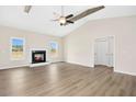 Spacious living room with fireplace, wood beams, and modern flooring at 618 Tart Town Rd, Dunn, NC 28334