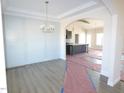 A view of the dining area flowing into the kitchen, featuring modern flooring and stylish lighting at 618 Tart Town Rd, Dunn, NC 28334