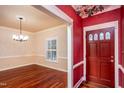Elegant entryway featuring beautiful hardwood floors and decorative wallpaper at 748 Weathergreen Dr, Raleigh, NC 27615
