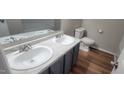 Bright bathroom features double sinks with modern fixtures and wood-look flooring at 806 Kendall Dr, Durham, NC 27703