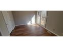 Bright bedroom featuring wood-look floors and a door to private outdoor deck at 806 Kendall Dr, Durham, NC 27703