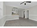 Open concept view of the bright living room featuring gray floors, white walls, and an open kitchen at 915 E Holly St, Rocky Mount, NC 27801