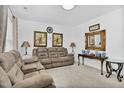 Bright living room with neutral walls, carpet, furnishings, and decorative wall art and mirror at 109 Mary Ln, Rocky Mount, NC 27803