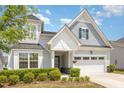 Charming home featuring a mix of gray shingle and lap siding and a black front door at 130 Ivory Ln, Raleigh, NC 27610