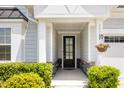 Close up of the entryway with a black front door and stylish stonework accents at 130 Ivory Ln, Raleigh, NC 27610