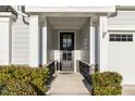 A welcoming front entryway with decorative stone accents and a black, glass-paneled door at 130 Ivory Ln, Raleigh, NC 27610