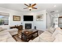 Inviting living room with hardwood floors, fireplace, ceiling fan and neutral decor at 130 Ivory Ln, Raleigh, NC 27610
