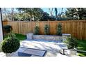 Secluded backyard featuring stone patio and beautiful green landscaping at 1317 Pecora Ln, Raleigh, NC 27607