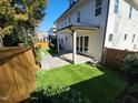 Backyard with privacy fence, patio, and lush artificial turf at 1317 Pecora Ln, Raleigh, NC 27607