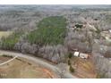 Beautiful aerial view of land parcel, home and storage shed with a long road frontage at 1469 Mollie Mooney Rd, Roxboro, NC 27574