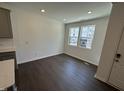 Bright dining area with wood floors, recessed lighting, and views of front yard at 1551 Crescent Townes Way, Raleigh, NC 27604
