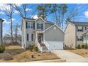 Inviting two-story home with white picket fence and attached front load two-car garage at 162 W Lumber Ct, Clayton, NC 27520