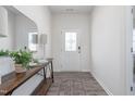 A welcoming entryway featuring a decorative front door, stylish console table, mirror, rug and wood flooring at 1752 Post Oak Dr, Haw River, NC 27258