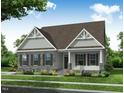 Rendering of a traditional home with stone accents, shutters, and a well-manicured lawn and garden at 190 Sage Ln # 015, Four Oaks, NC 27524