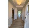 Bright foyer with light-colored wood floors and white wainscoting, leading into an open floor plan at 190 Sage Ln # 015, Four Oaks, NC 27524