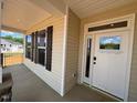 Inviting front porch with stone base columns and white trim around the windows and the front door at 190 Sage Ln # 015, Four Oaks, NC 27524