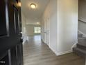 Bright foyer with hardwood floors, white walls, and a glimpse into the open living space and stairway at 209 Deodora Ln, Cameron, NC 28326