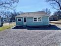 Cozy home with light blue siding, complemented by a gravel backyard and a fenced perimeter at 212 Craig Ave, Henderson, NC 27537