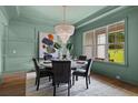 Elegant dining room featuring a stylish chandelier, modern decor, and plenty of natural light at 2325 Ballywater Lea Way, Wake Forest, NC 27587