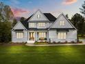 Beautifully built, new traditional home with a manicured lawn and a covered front porch perfect for relaxing at 2325 Ballywater Lea Way, Wake Forest, NC 27587