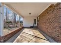 Covered carport with brick accents offering convenient access to the home and outdoor storage, next to a brick home at 2409 Parkway Dr, Raleigh, NC 27603