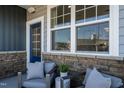 Cozy front porch seating area with stylish chairs, perfect for relaxing and enjoying the outdoors at 2465 Englemann Dr # 365, New Hill, NC 27562