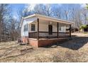 Single-story home featuring a covered front porch perfect for relaxing at 2810 Hickory Hill Rd, Burlington, NC 27215
