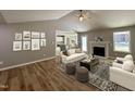 Open-concept living room with a fireplace, wood floors, and stylish decor, creating a cozy and inviting space at 349 Earnest Way # 21, Kenly, NC 27542