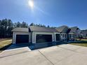 Beautiful single-story home featuring a three-car garage and a pristine concrete driveway at 349 Earnest Way # 21, Kenly, NC 27542