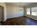 Dining room with hardwood floors, chandelier, and large windows at 377 Earnest Way, Kenly, NC 27542