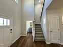 Bright foyer with hardwood floors, staircase, and view of a half bathroom at 377 Earnest Way, Kenly, NC 27542