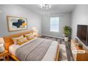 Bright bedroom featuring a wood frame bed, stylish decor and a leafy plant in a modern setting at 3804 Prince Noah, Wake Forest, NC 27587