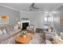 Staged living room showcasing a cozy fireplace and neutral color palette at 3804 Prince Noah, Wake Forest, NC 27587