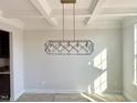 Dining area with white coffered ceilings, large windows, and a modern, linear pendant light at 44 Blue Iris Pkwy # 121, Clayton, NC 27520