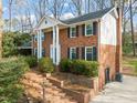 Side view of a traditional brick home, illustrating its architectural details and landscaping at 5620 Winthrop Dr, Raleigh, NC 27612