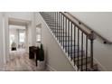 Elegant staircase with dark metal railings and wood treads, leading to the upper level at 641 Emerald Bay Cir # 820 Somerset, Raleigh, NC 27610