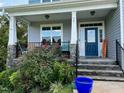 Inviting front porch with stone accents, and a cozy seating area at 70 Maxwell Pl, Lillington, NC 27546