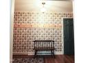 Entryway featuring hardwood floors, patterned wallpaper and a charming wooden bench at 711 Stuart Dr, Sanford, NC 27330