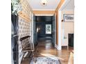 Stylish foyer with hardwood floors, patterned wallpaper, and a charming wooden bench at 711 Stuart Dr, Sanford, NC 27330
