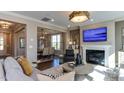 Comfortable living room with a fireplace, hardwood floors, and access to the dining area at 840 Emerald Bay Cir, Raleigh, NC 27610