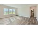 Spacious bedroom with large windows offering ample natural light and wood flooring at 924 Jasper Mine Trl, Raleigh, NC 27610