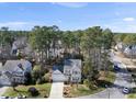 Aerial view of a residential neighborhood featuring homes with well-maintained lawns and mature trees on a sunny day at 102 Ashley Brook Ct, Cary, NC 27513