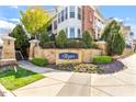 The Cottages at Brier Creek entrance featuring stone wall with landscaping and well manicured shrubbery at 10321 Sablewood Dr # 108, Raleigh, NC 27617