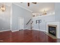 Bright living room with a fireplace, hardwood floors, and a staircase leading to the second floor at 10321 Sablewood Dr # 108, Raleigh, NC 27617